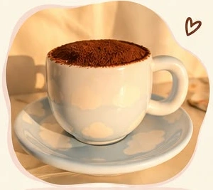 Tiramisu in a cream-colored mug and saucer